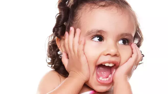 Little girl, hands on face, laughing
