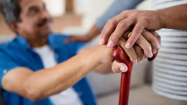 Holding hands on cane.