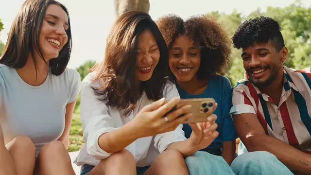 Young adults smiling looking at a phone